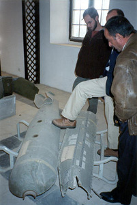 Members of the Church of the Brethren delegation to Iraq examine a "cluster bomb" made in the USA, a weapon designed to kill people - men, women and children.